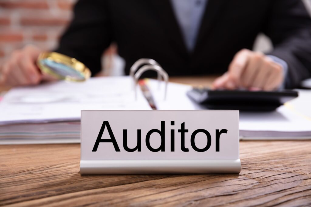 Auditor reviewing financial documents in preparation for the future of auditing in 2025.