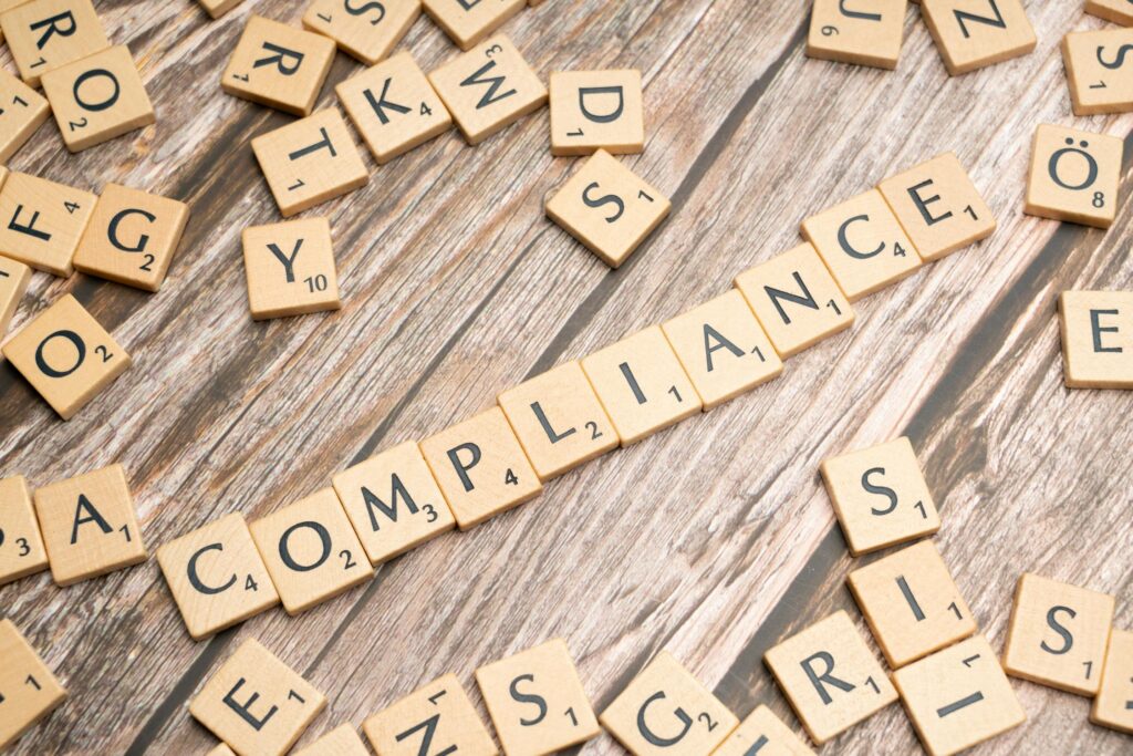 Abstract illustration of a secure shield icon representing compliance in financial technology.