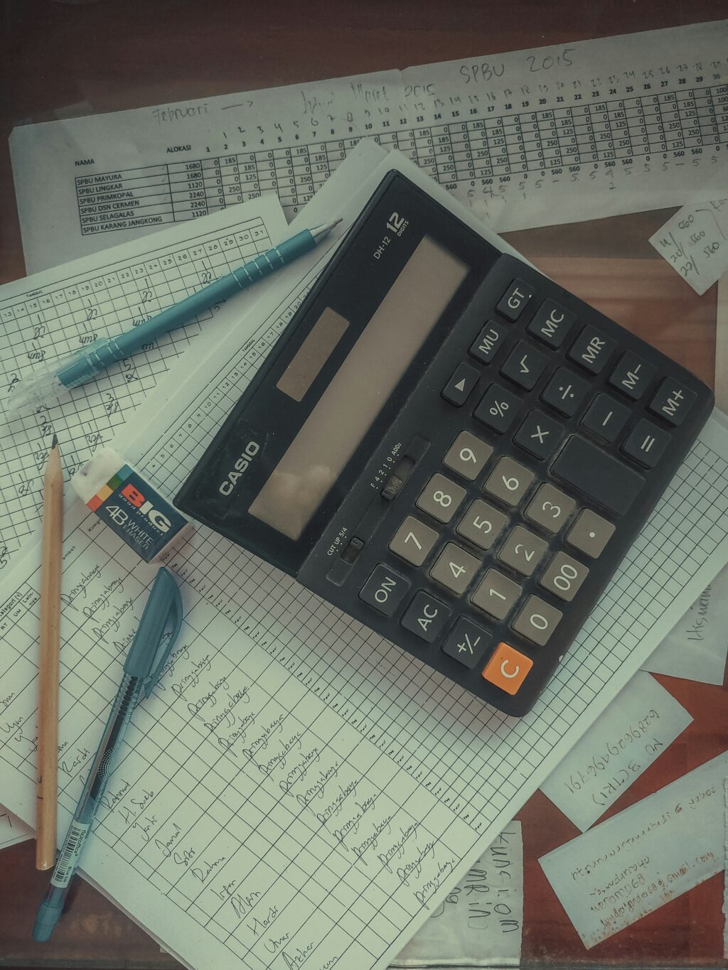 Bookkeeping profession workers using computers and AI technology in modern office showing employment decline trends.