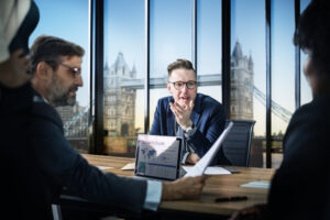 Accountants working together in an office discussing financial reports and AI tools shaping accounting jobs in 2026